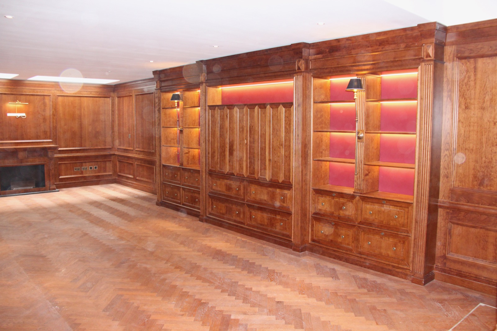 Bespoke timber library joinery with illuminated shelving